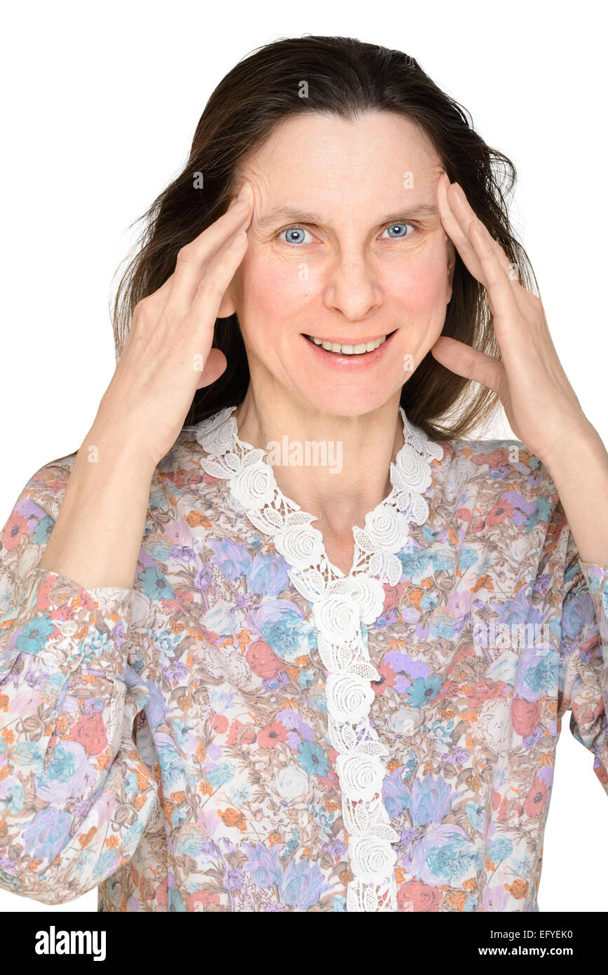 A smiling mature woman puts the fingers on the temple to show that she is thinking about something important Stock Photo