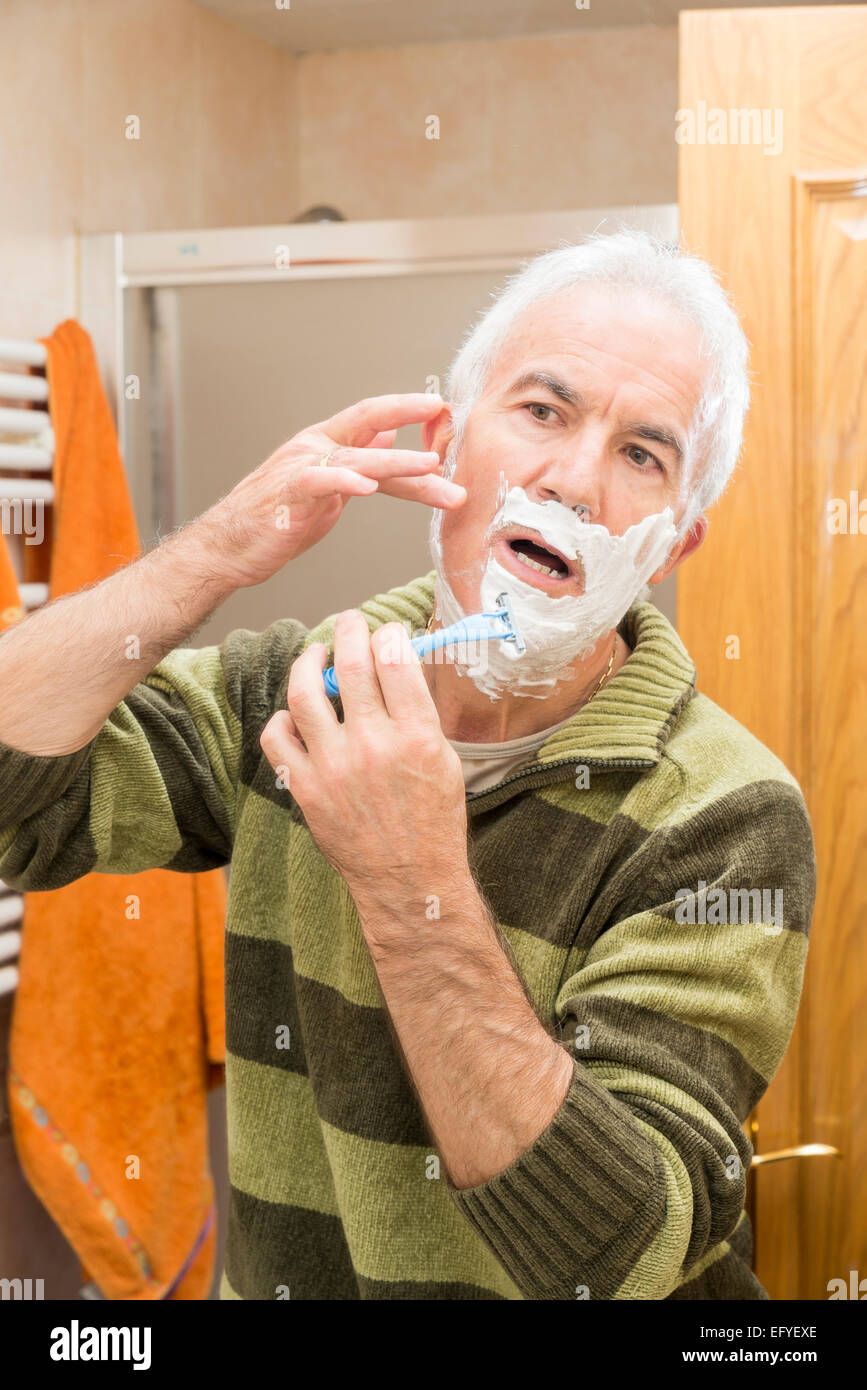 Man shaving in the bathroom Stock Photo