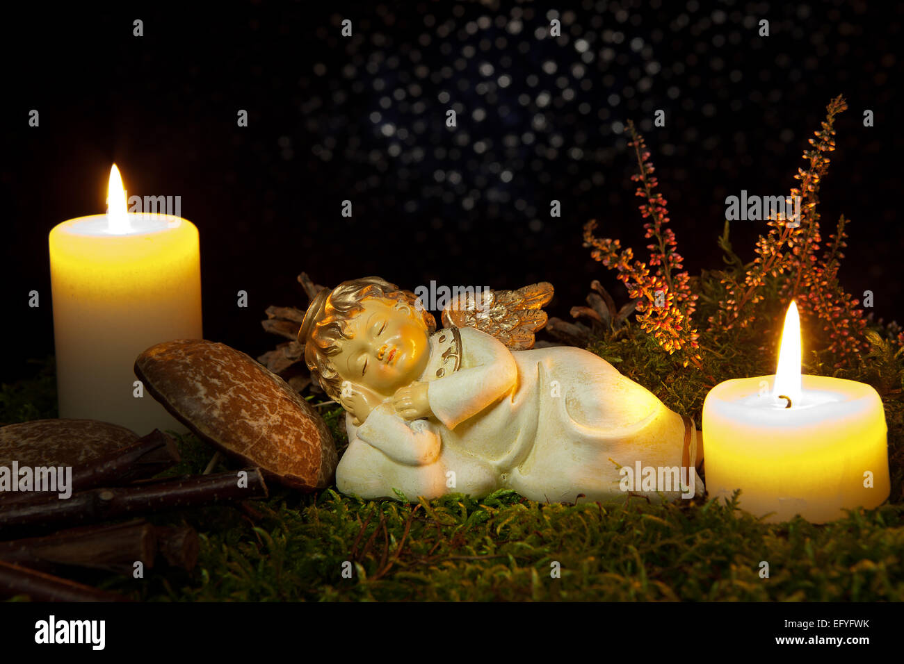 Christmas decoration, angel sleeping by candlelight Stock Photo