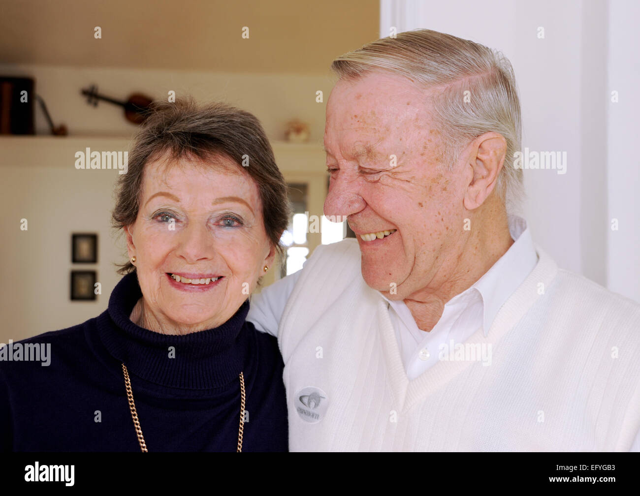 Elderly pensioners couple male and female in their 80s still in love looking happy and smiling Stock Photo