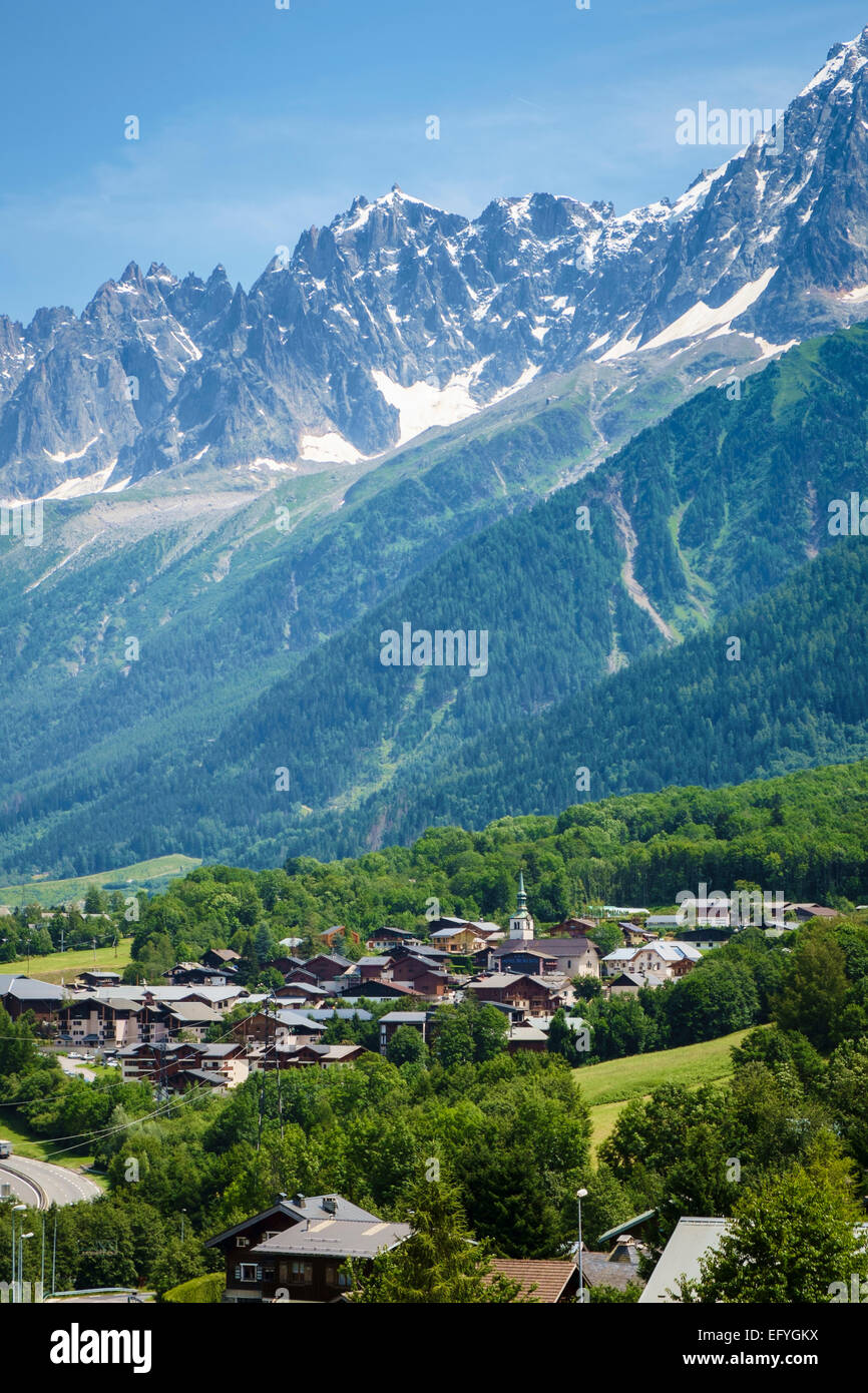Les Houches ski resort village with the Aiguilles de Chamonix range behind, Chamonix Valley, France, Europe Stock Photo