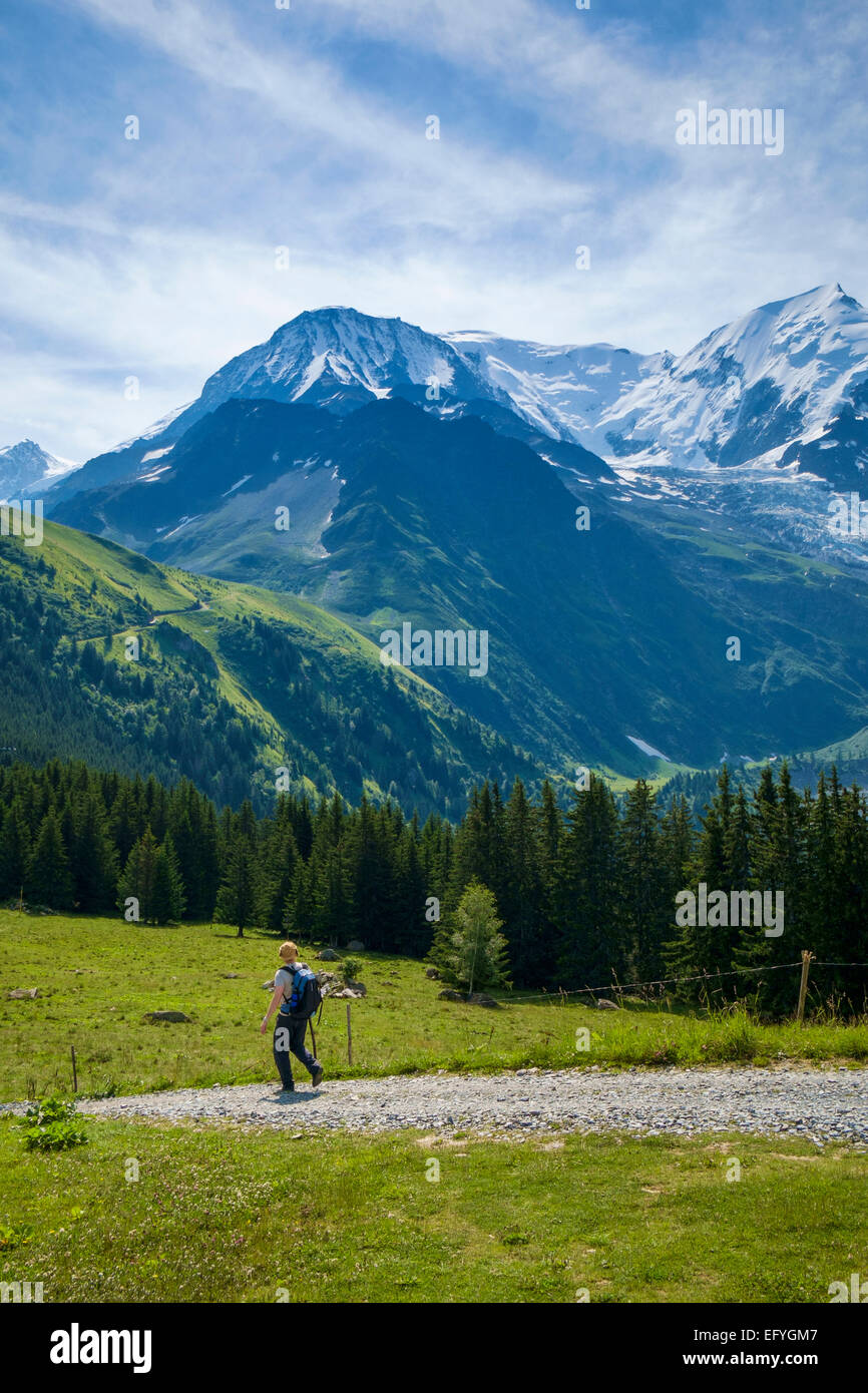 Walker on a path with Mont Blanc behind, French Alps, France, Europe Stock Photo