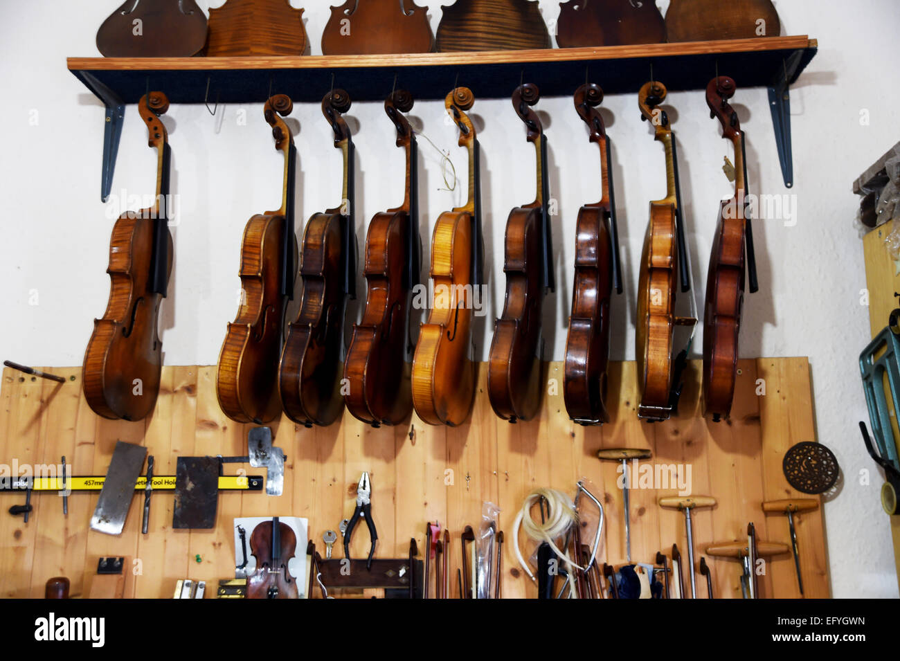 Violins hanging on a wall Stock Photo Alamy