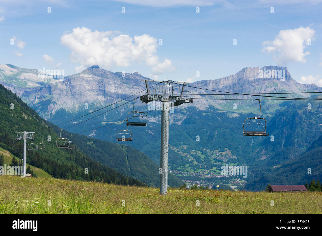 Ski lift with Rocher des Fiz mountain range and Servoz behind near Chamonix in the French Alps, France, Europe in summer Stock Photo