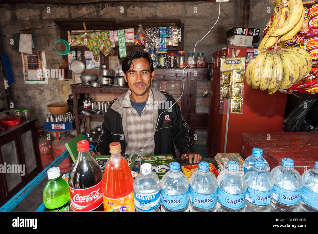 Nepalese seller in a small food store in Sauraha, Nepal Stock Photo Alamy