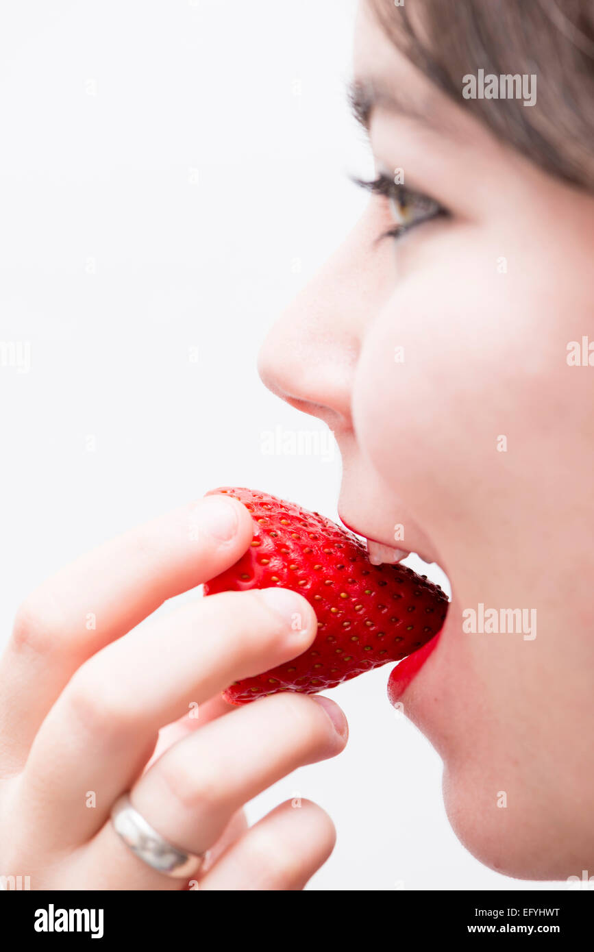 beautiful woman eating a strawberry Stock Photo