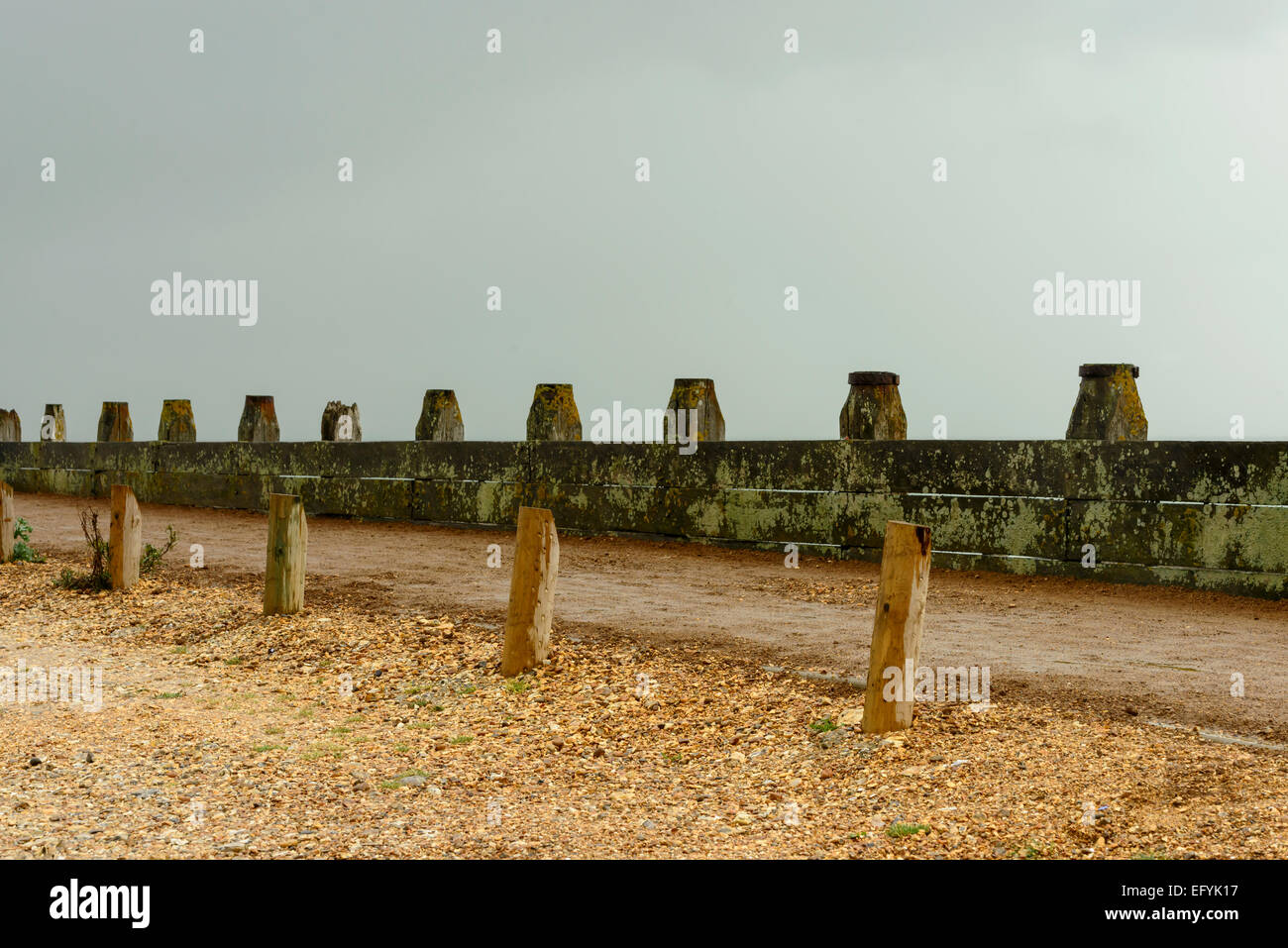 detail of foot path delimitation at shingle beach of touristic location, shot under bright cloudy sky Stock Photo