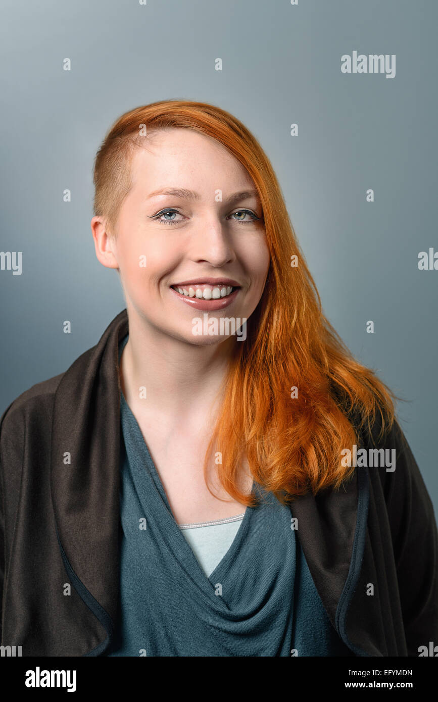 Close up Portrait of Smiling red haired Woman Looking at the Camera Stock Photo