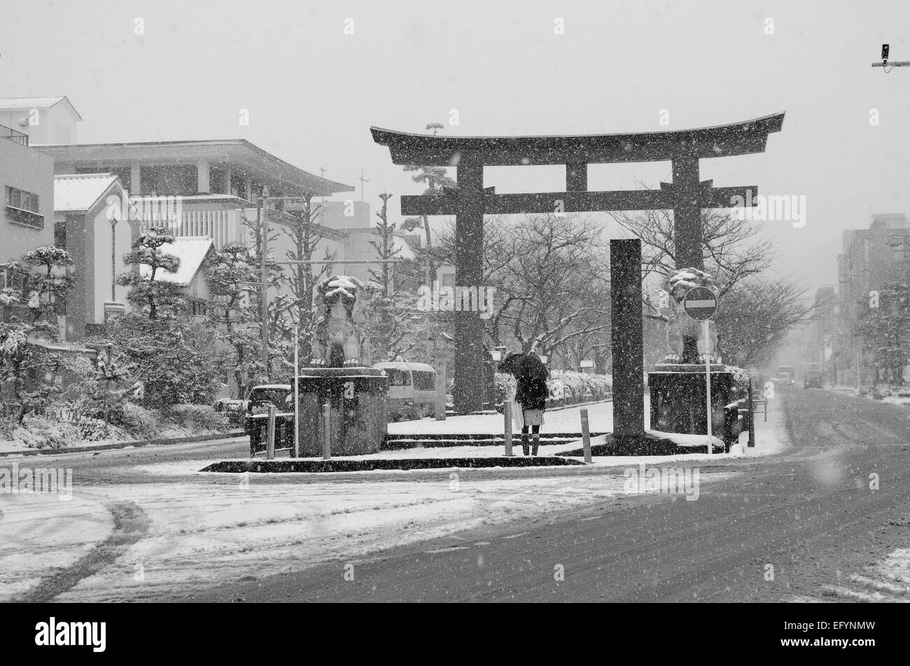 A torii gate in Kamakura, Japan during a snow storm. Stock Photo
