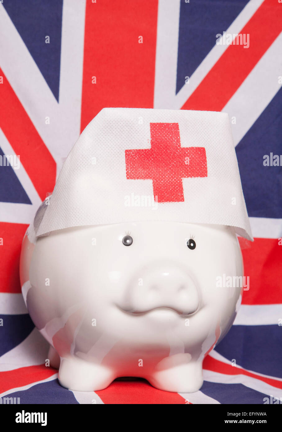 piggy bank wearing nurse hat on british flag Stock Photo