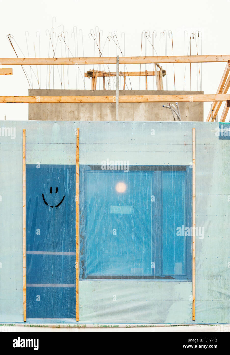 Smiling face cut out in plastic on construction site in Stockholm, Sweden. Stock Photo