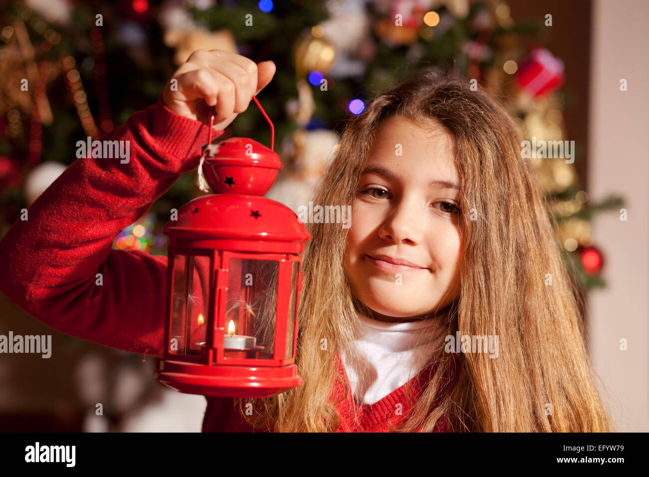 Little girl holding red Christmas lamp Stock Photo Alamy