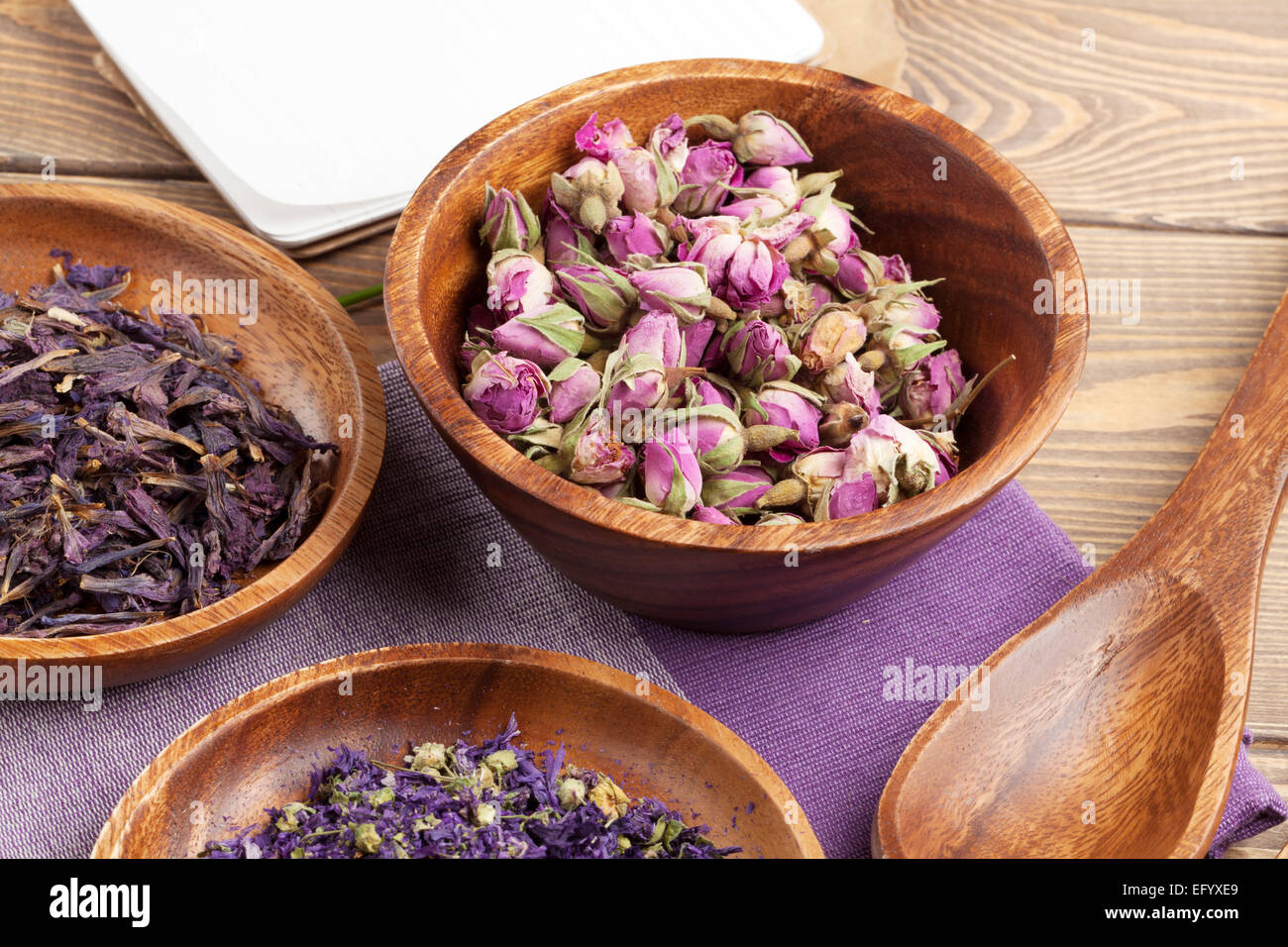 Purple spices and utensils over wooden table Stock Photo
