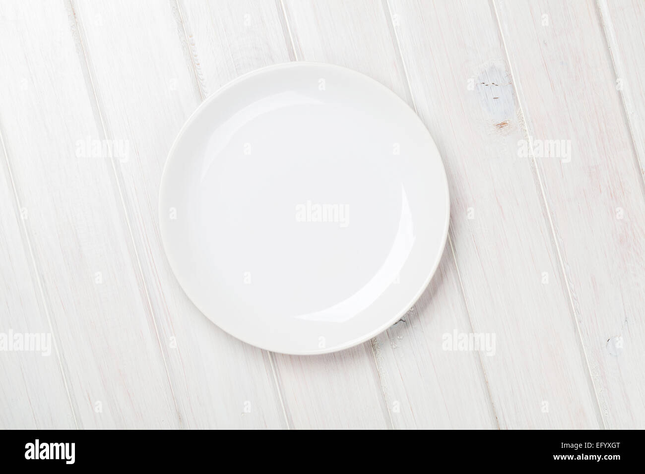 Empty plate over white wooden table background with copy space Stock ...