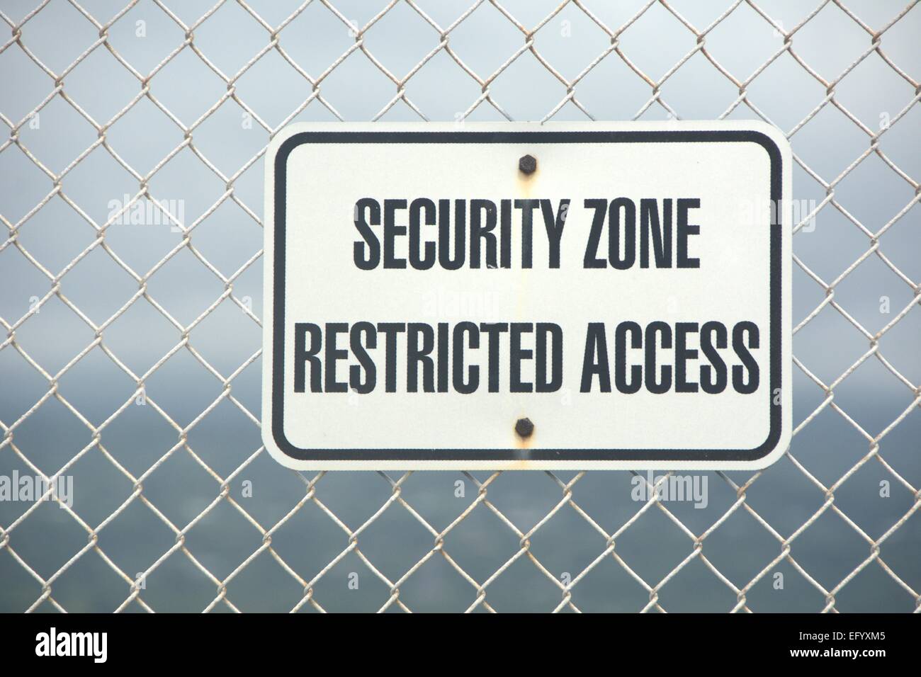 Security zone restricted access sign on  a wire mesh fence Stock Photo