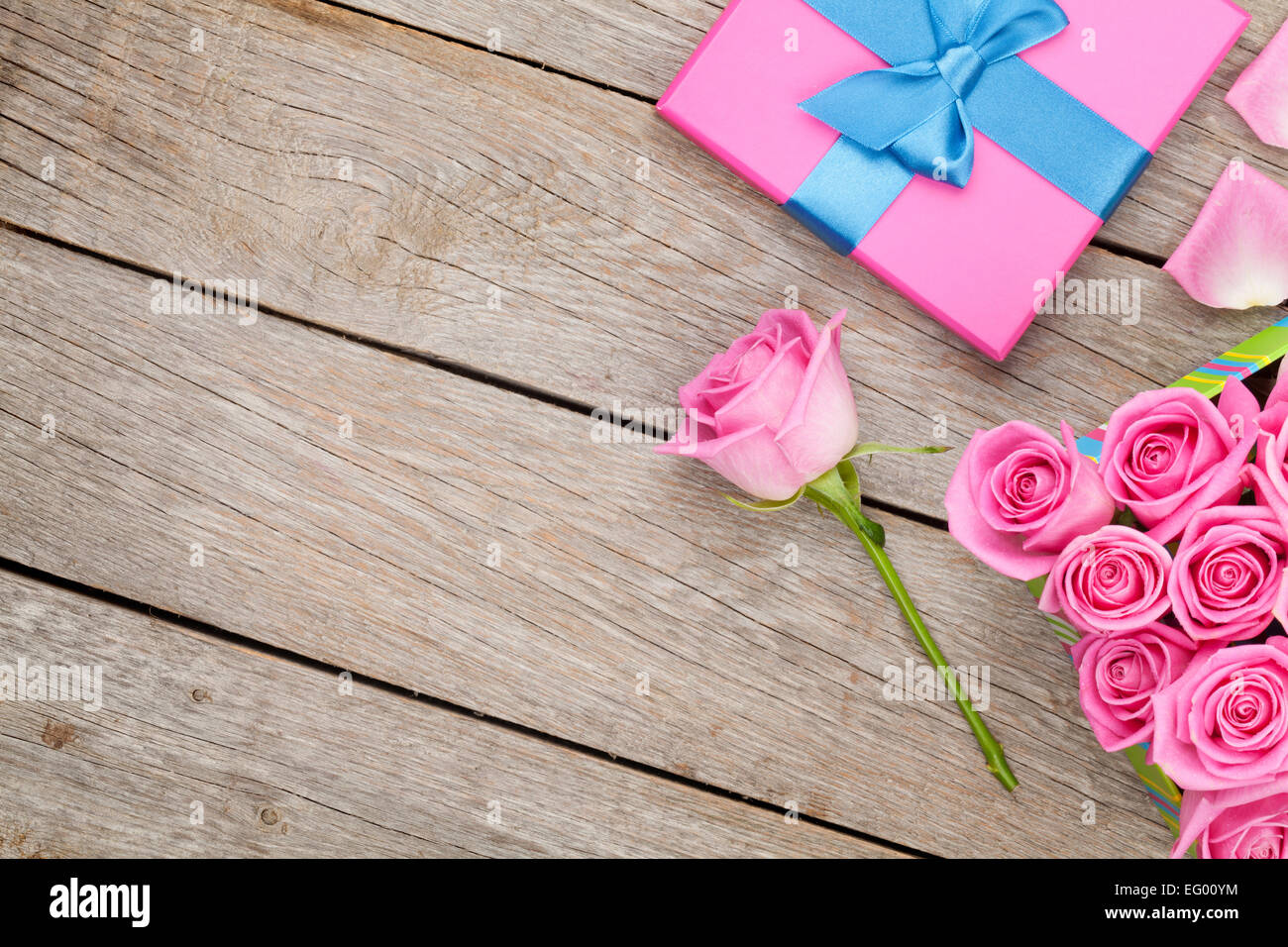Valentines day background with gift box full of pink roses over wooden ...