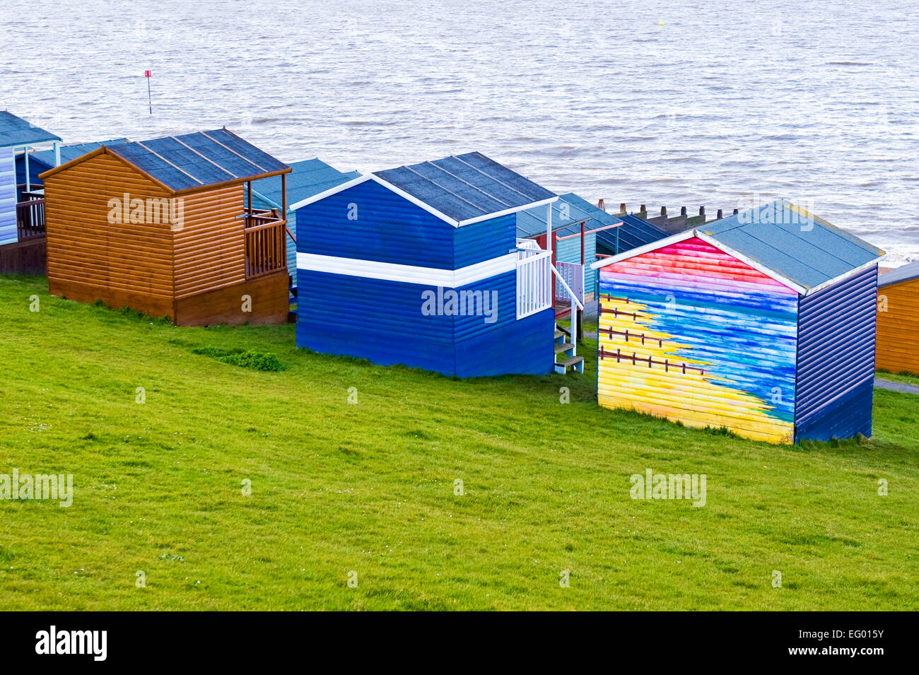 colourful wooden beach huts overlooking the sea at Tankerton near Whitstable Kent Stock Photo