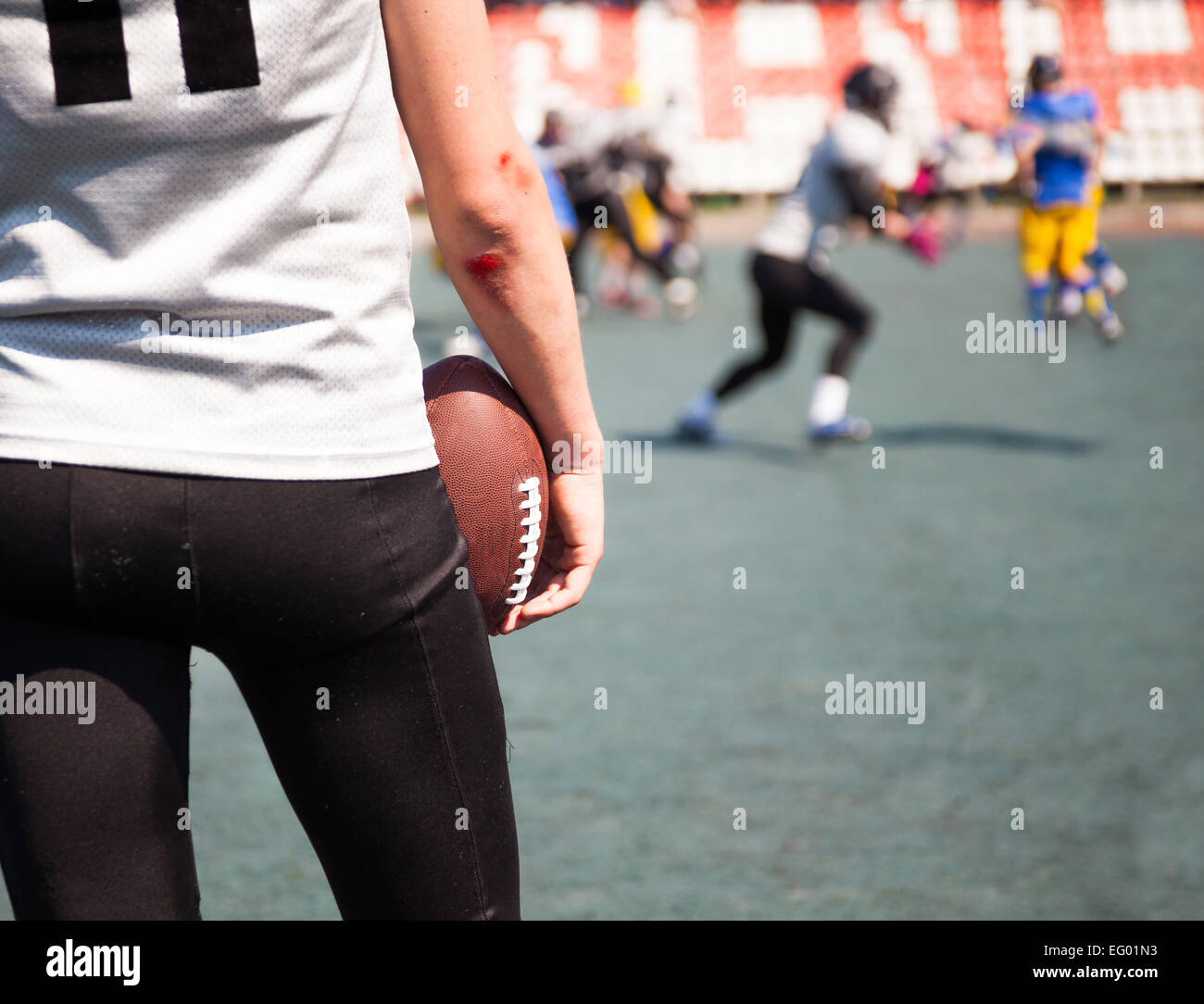 athlete American football with broken elbows keeps the ball Stock Photo