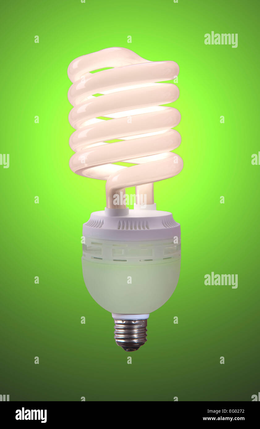 low energy light bulb glowing against a coloured background Stock Photo