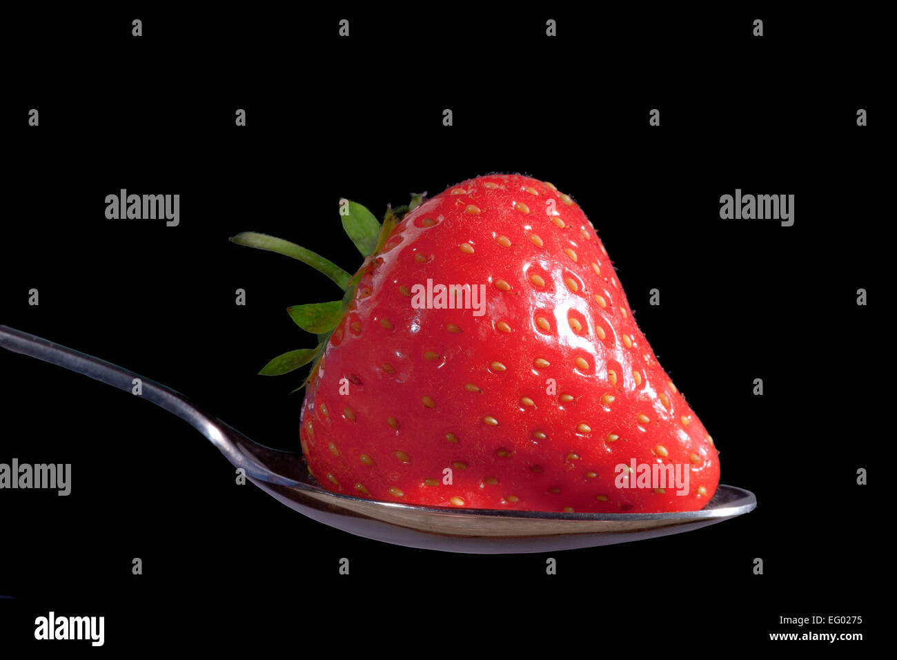 strawberries fruit against a black background Stock Photo - Alamy