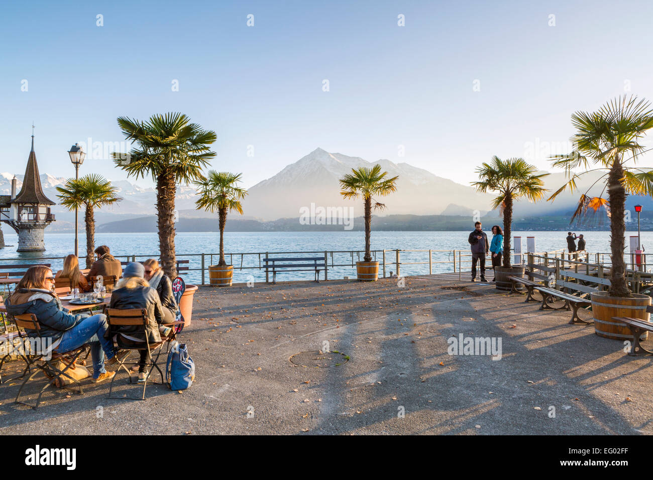 Restaurant with Lake Thun and Oberhofen Castle in the background, Thunersee, Bernese Oberland, Switzerland Stock Photo