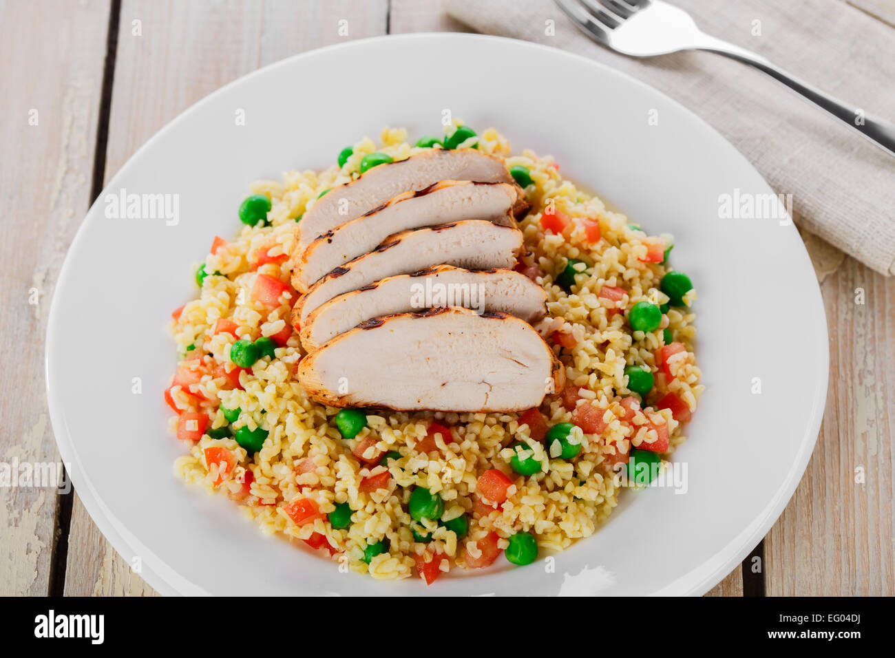 couscous with green peas and chicken fillet grill Stock Photo