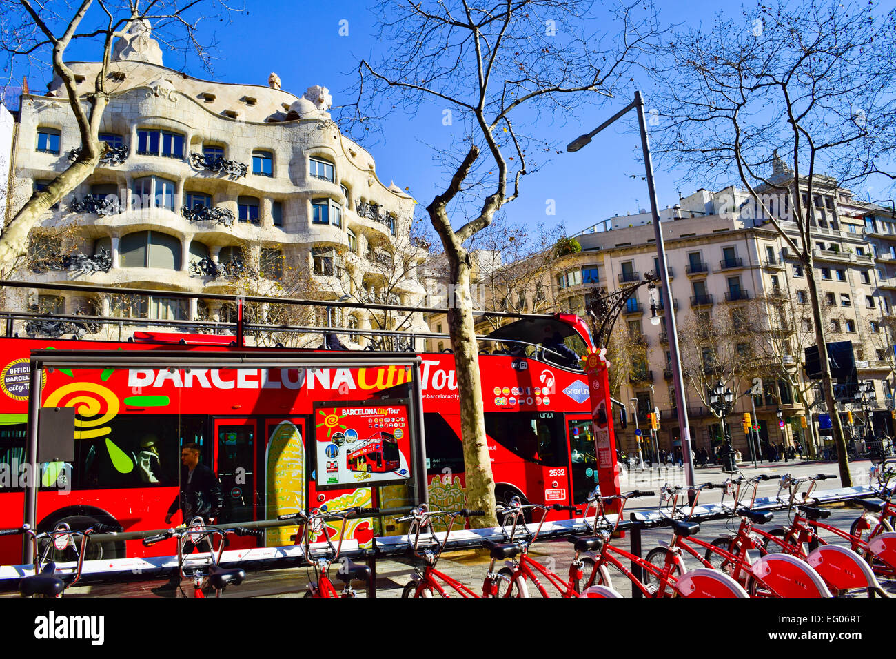 Barcelona city tour bus in a front of Mila house aka La Pedrera designed by Antoni Gaudi. Barcelona, Catalonia, Spain. Stock Photo