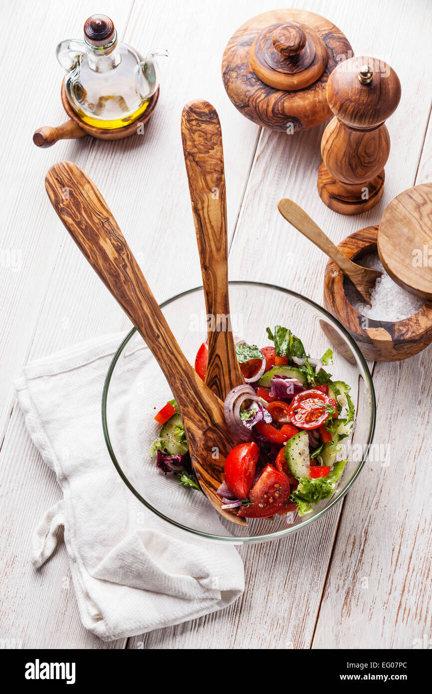 Fresh vegetable salad and olive wood tableware Stock Photo