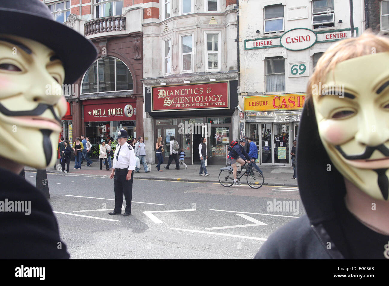 Scientology protest in Guy Fawkes masks in font of Dianetics and Scientology Life improvement center London Stock Photo