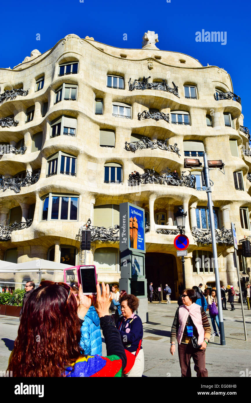 Tourist taking photos. Mila house aka La Pedrera. Designed by Antoni