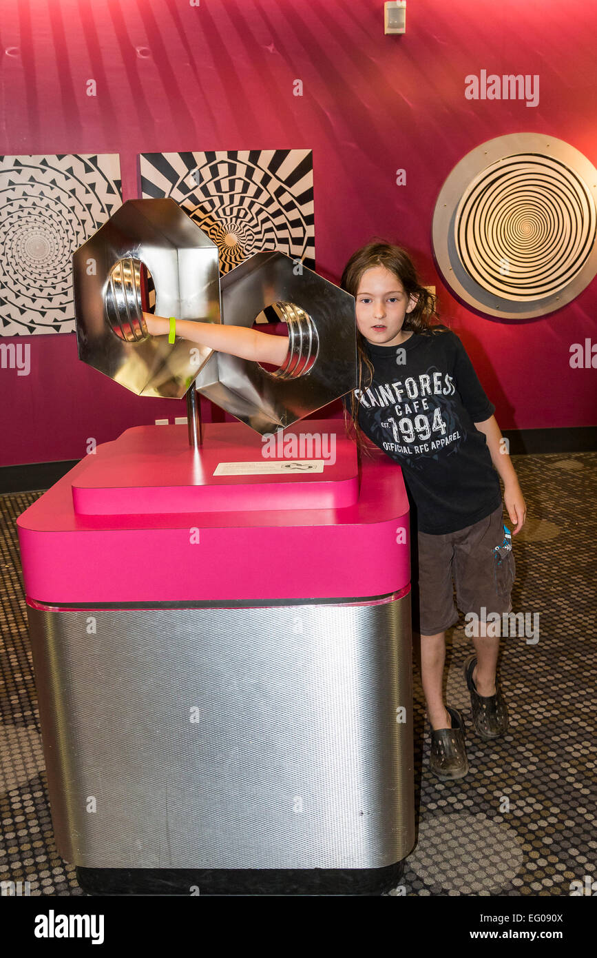 Boy interacting with optical illusion display at Telus, World of