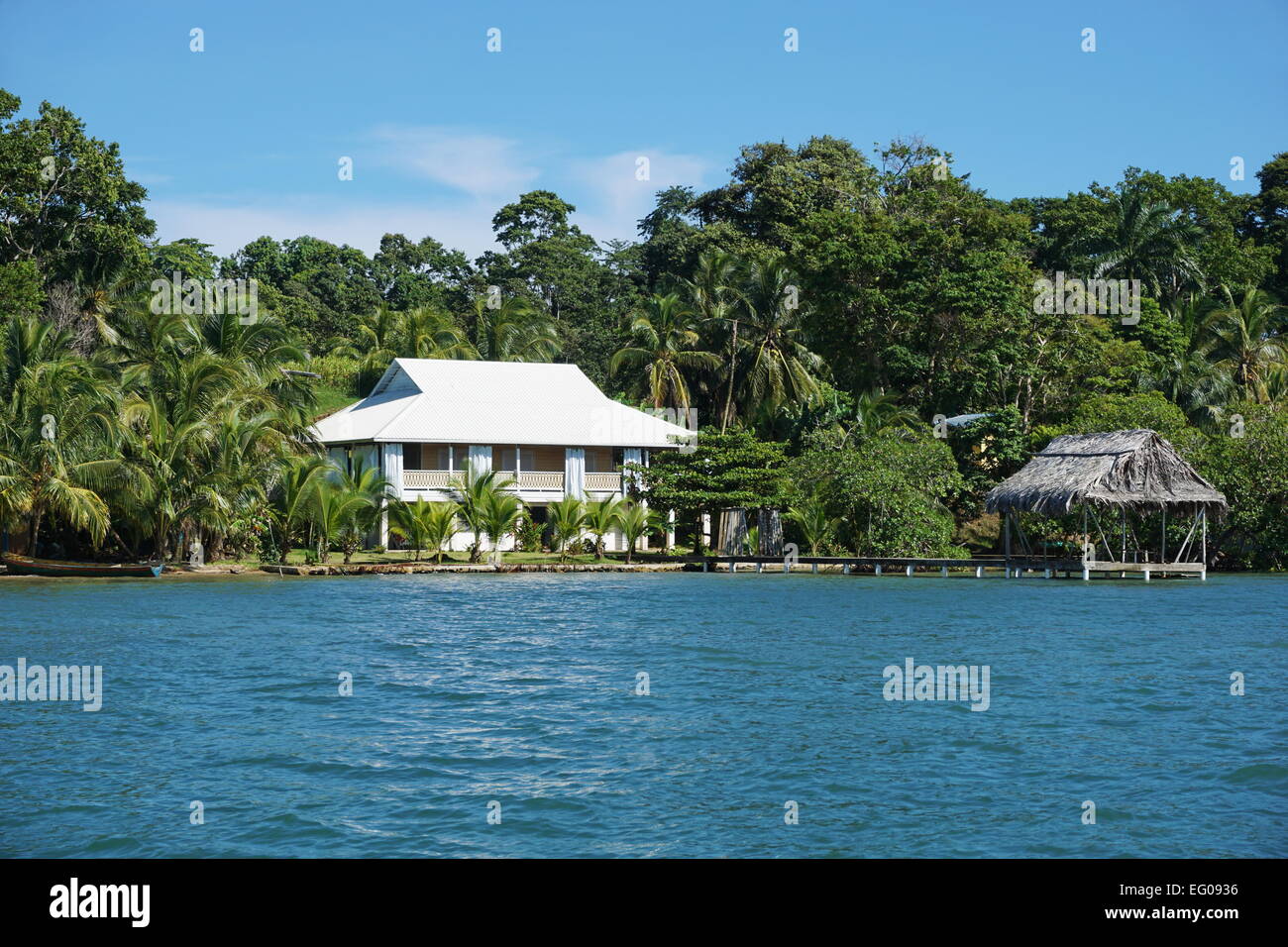 Oceanfront property with a Caribbean house and a tropical hut over the