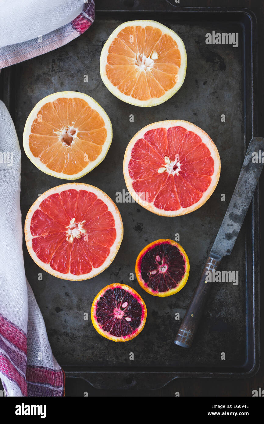 Pink grapefruit and blood oranges on a baking tray. Stock Photo