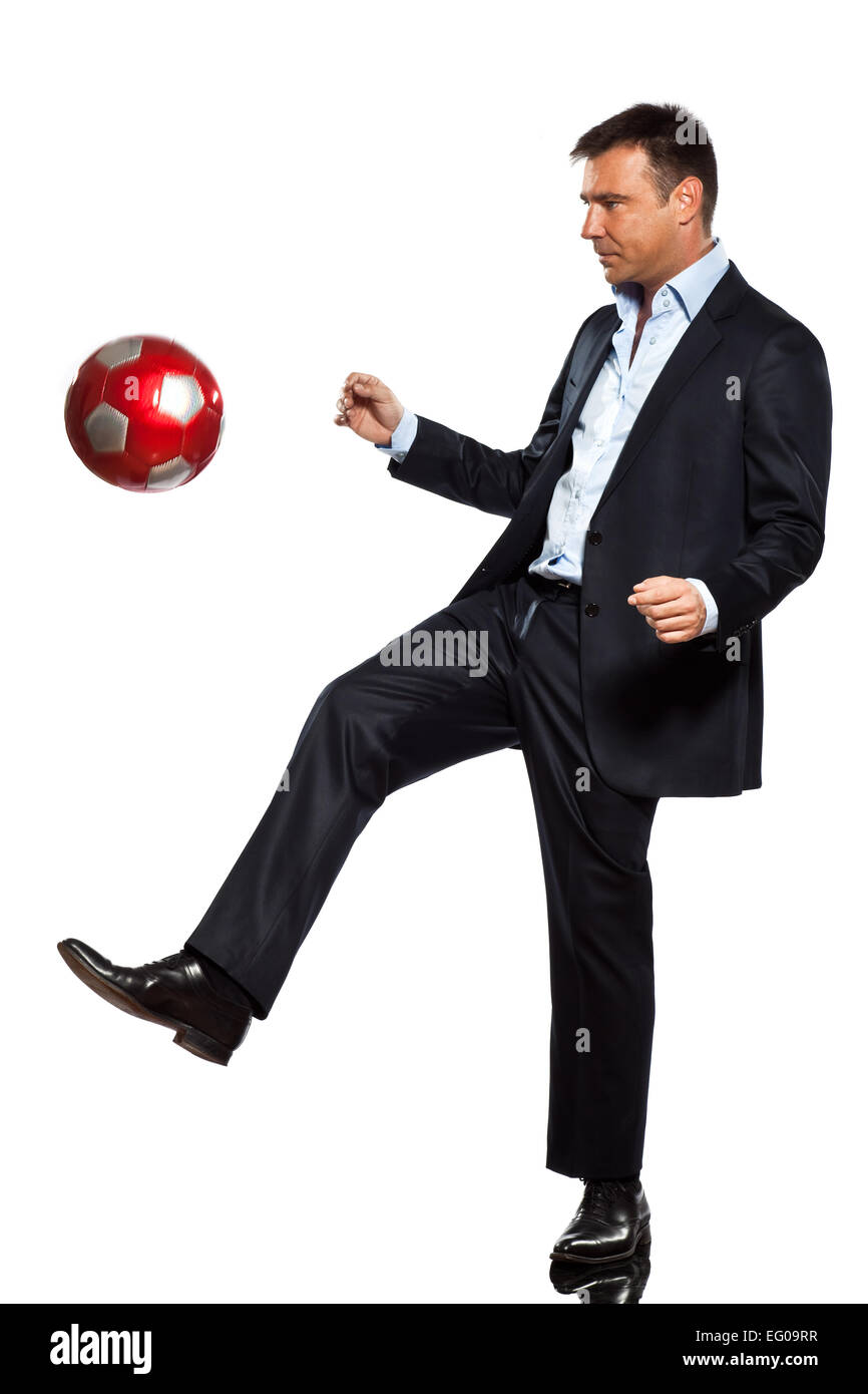 one caucasian business man playing juggling soccer ball in studio