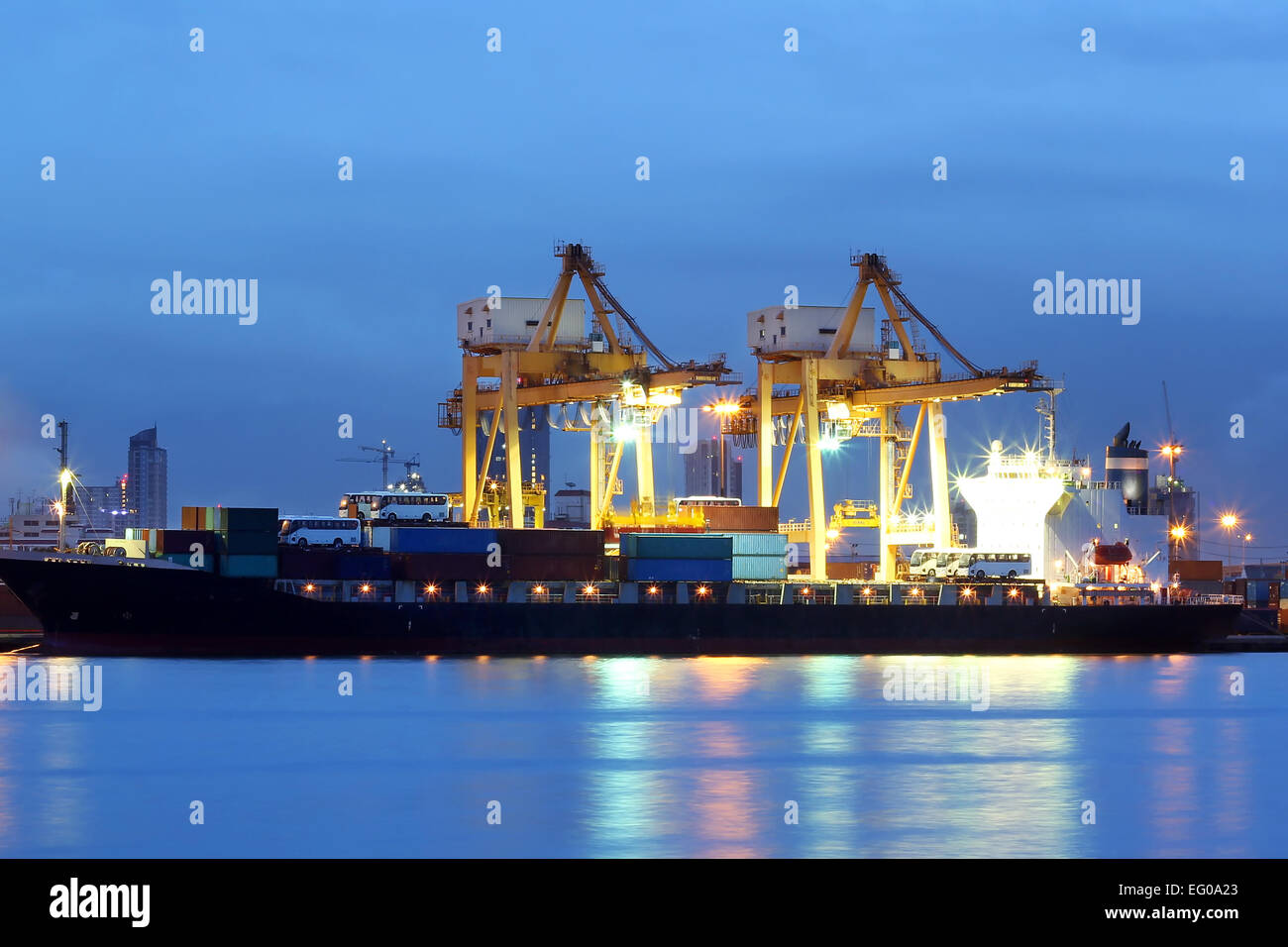 Container Cargo freight ship with working crane at twilight time Stock ...