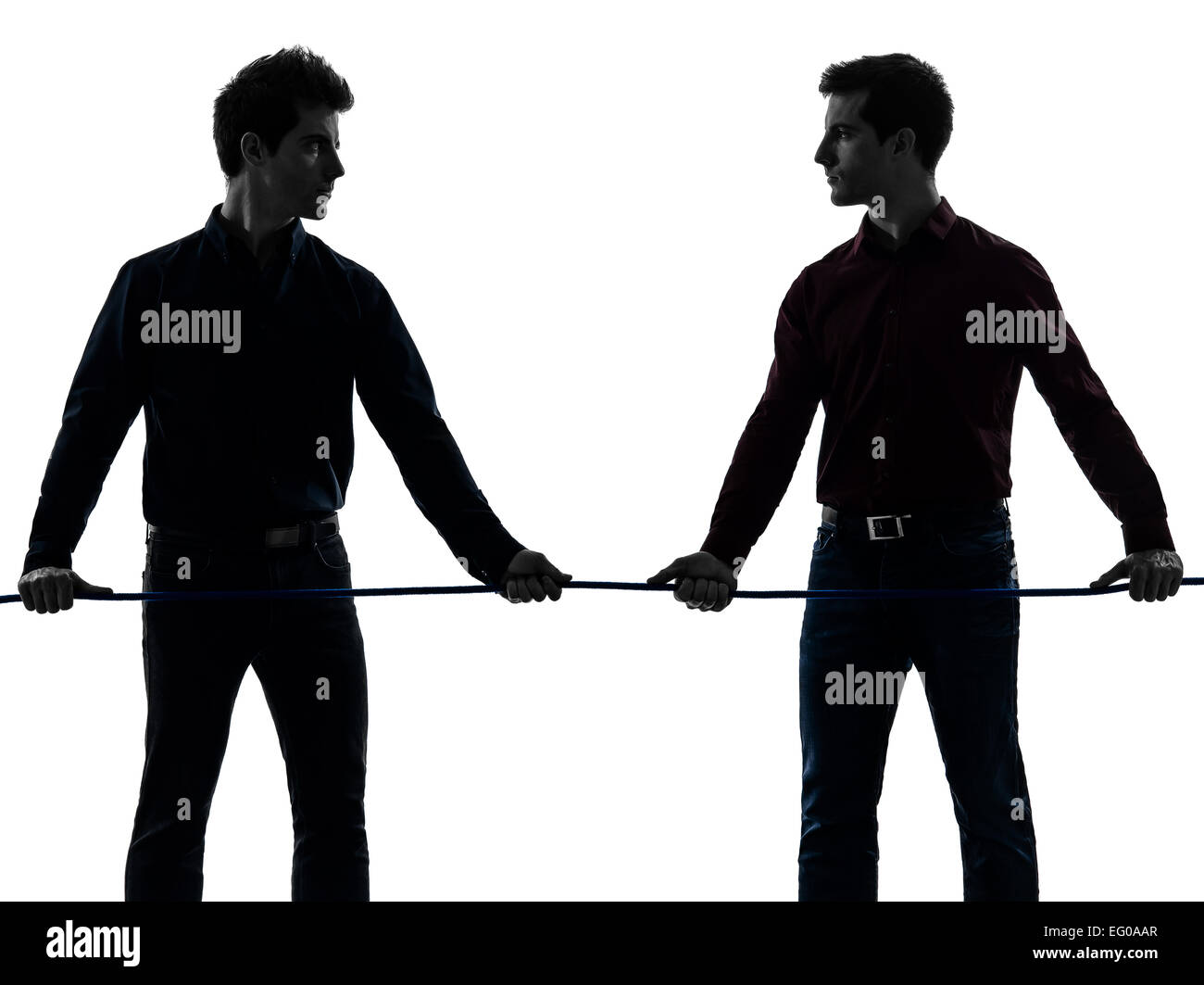 two young men tug of war in shadow white background Stock Photo - Alamy