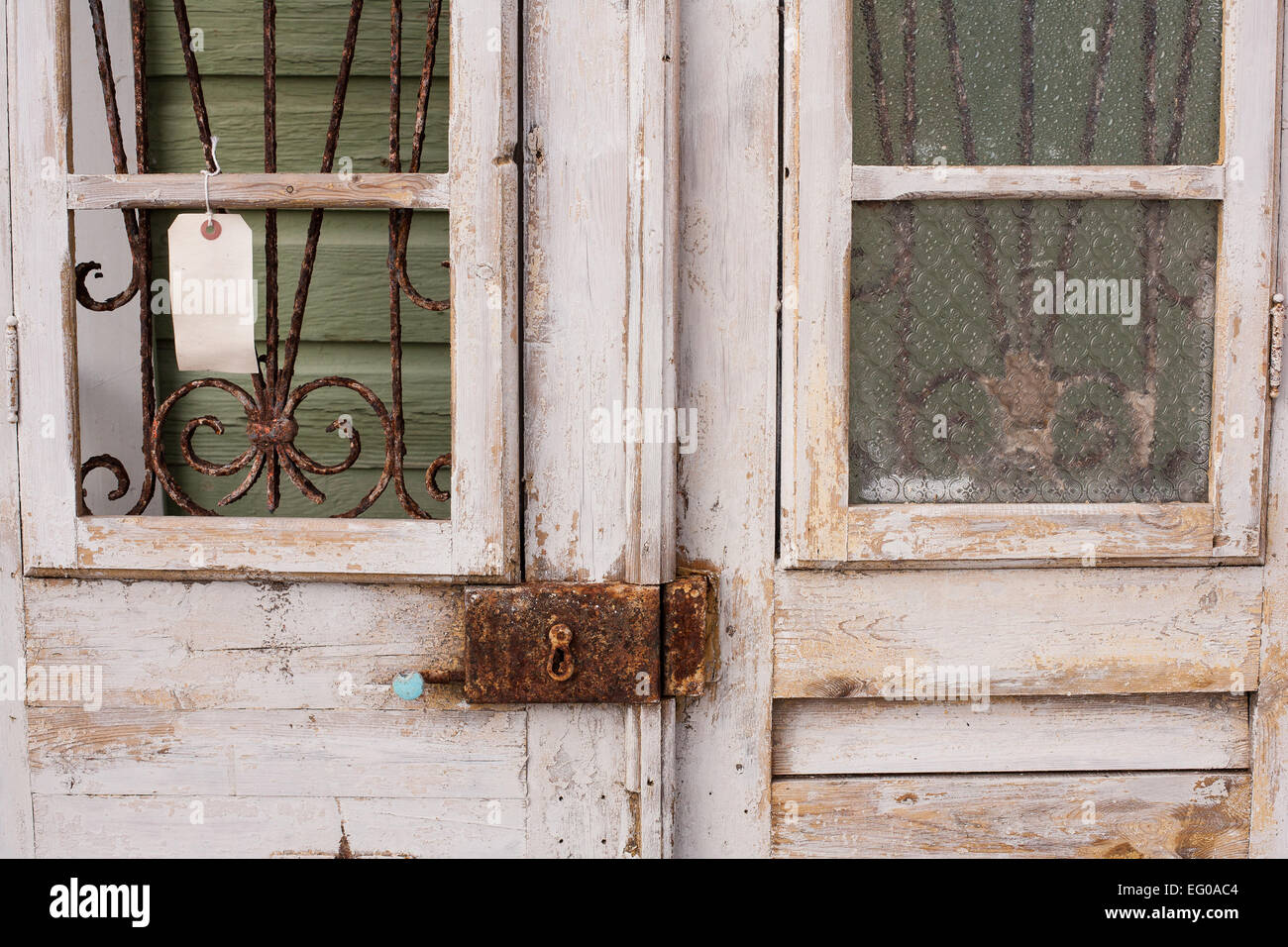 Old double wooden doors with rusted antique lock displayed at antique