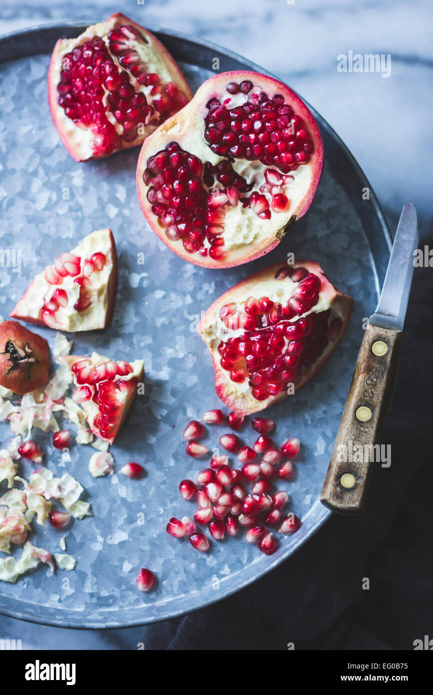 Pomegranate and seeds on a tray Stock Photo