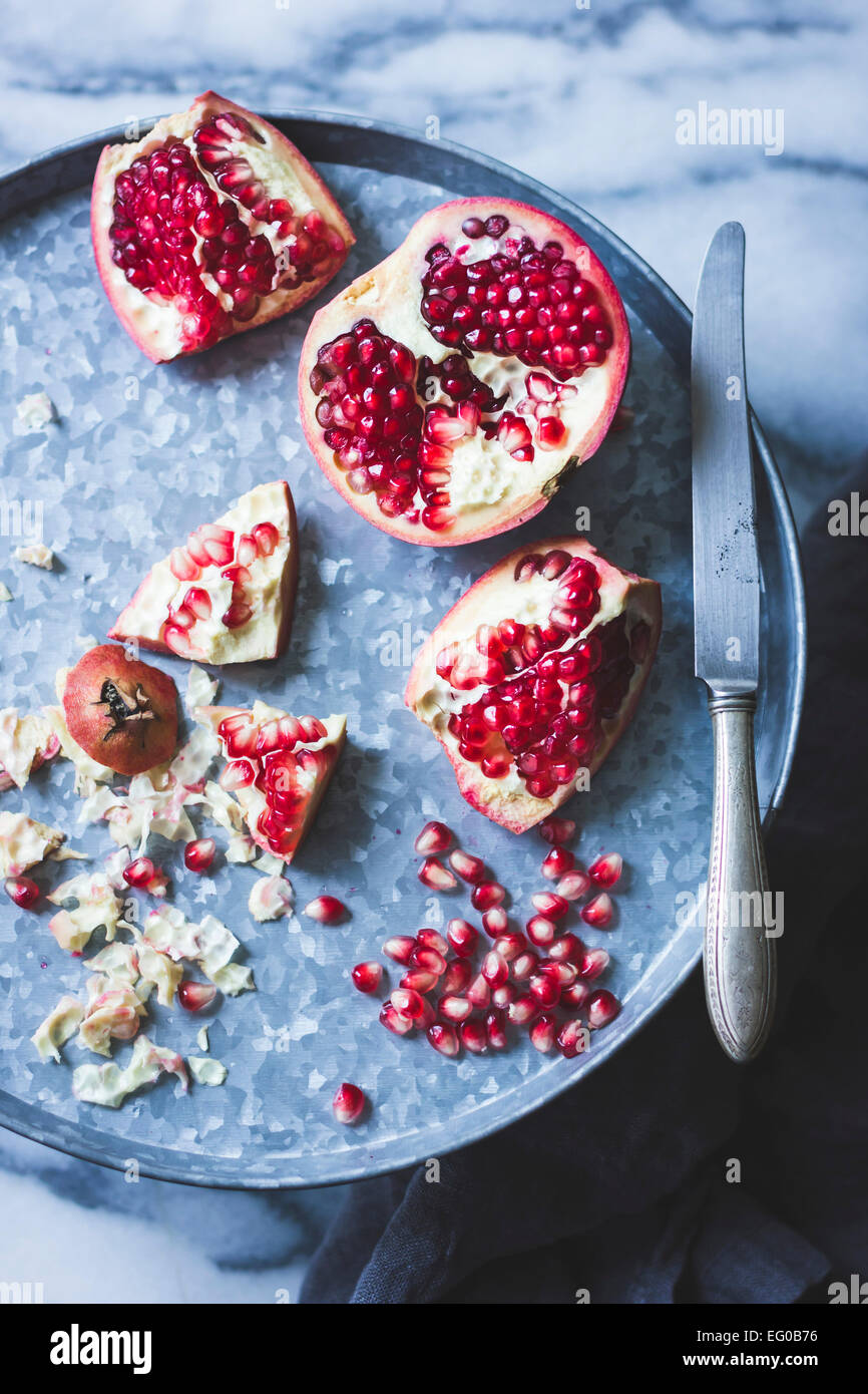 Pomegranate and seeds on a tray Stock Photo