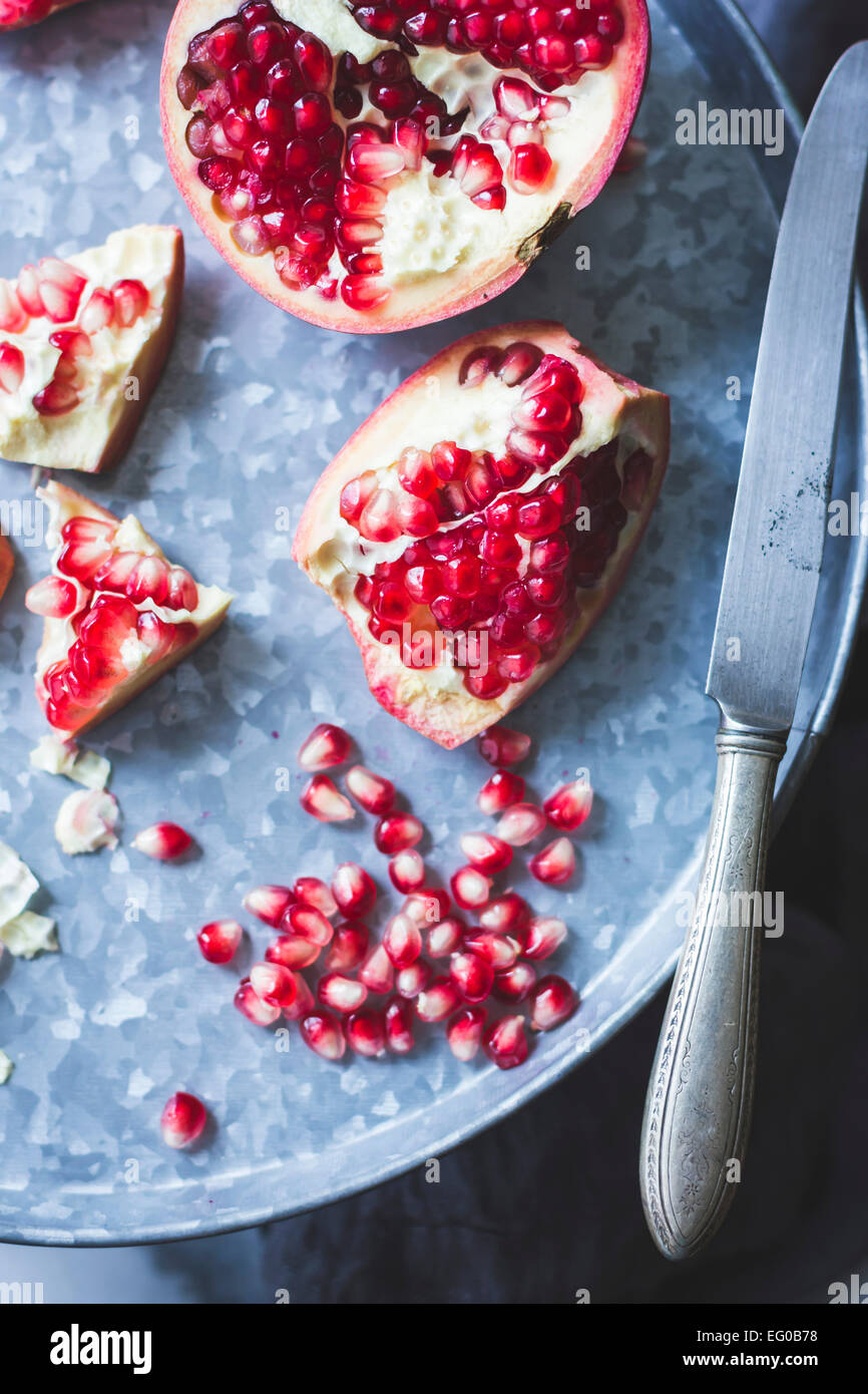 Pomegranate and seeds on a tray Stock Photo