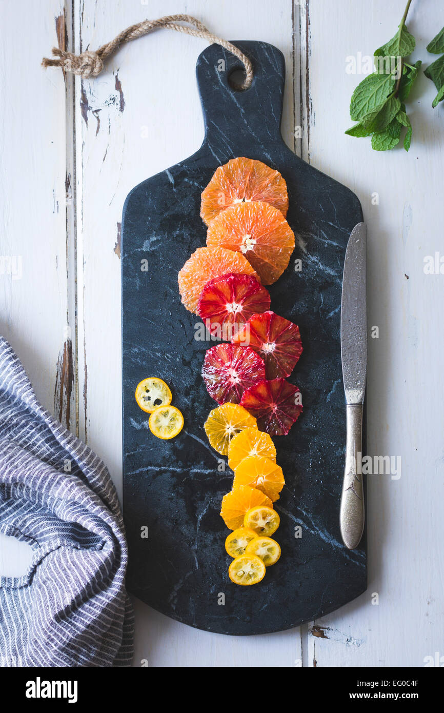 Citrus fruits on a marble chopping board. Stock Photo