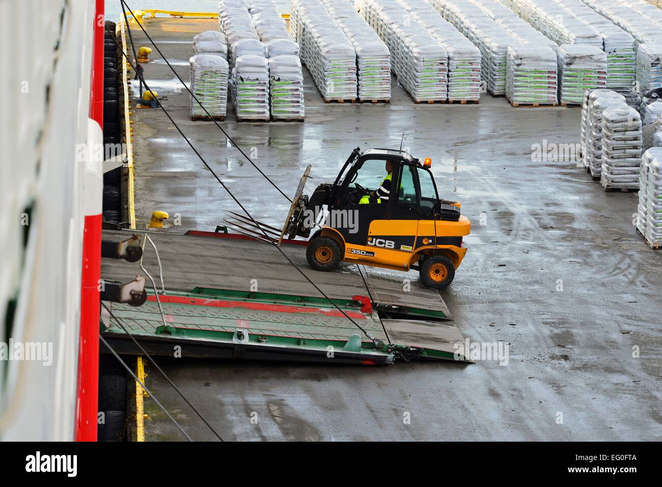 Forklift by the loading process at the Hurtigruten Terminal in Risøyhamn, 26 February 2014 Stock Photo