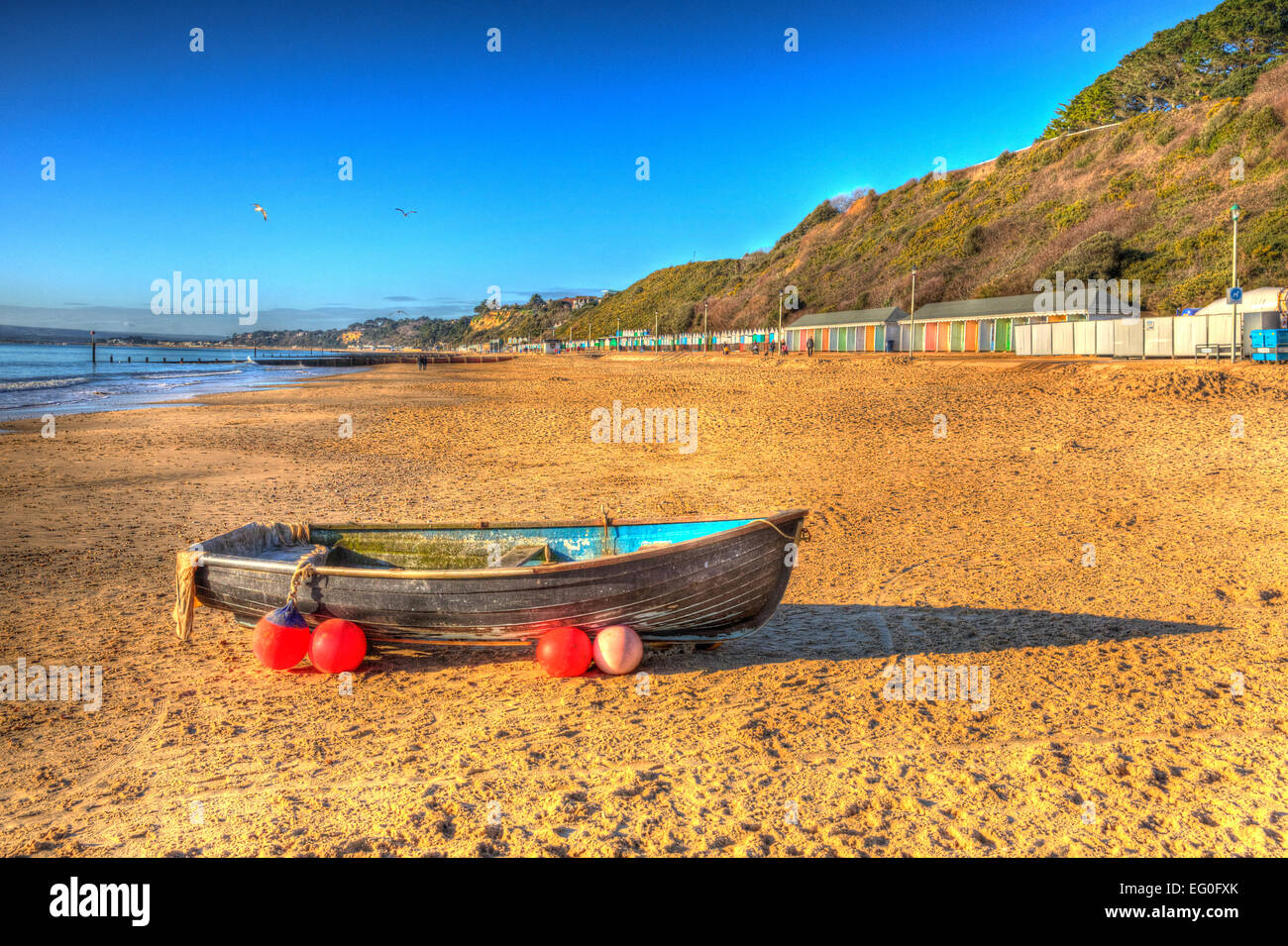 Boat on Bournemouth beach Dorset England UK like a painting in vivid bright colour HDR Stock