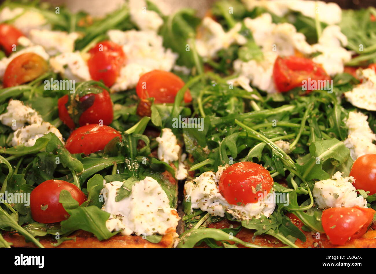 Tasty italian pizza with tomato, rocket and mozzarella Stock Photo Alamy