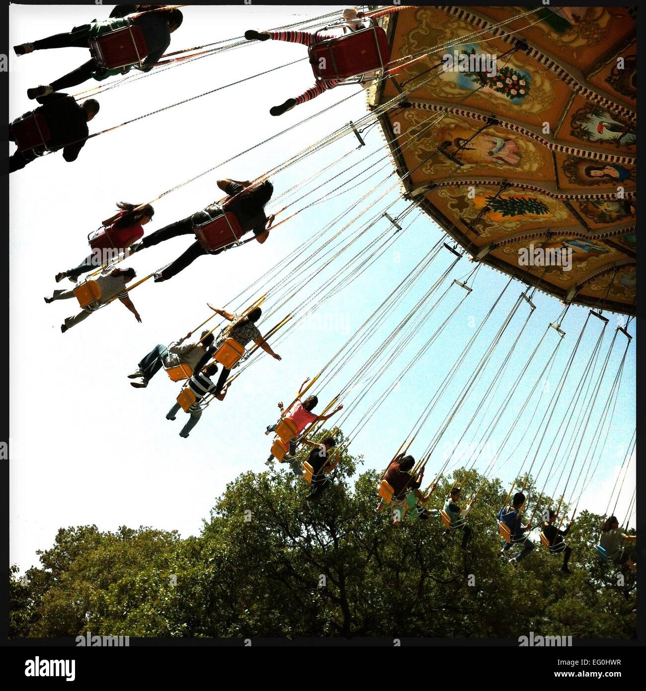 Low angle view of swing ride in amusement park Stock Photo - Alamy