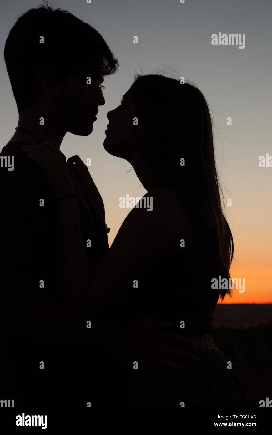 Silhouette of a couple embracing at sunset Stock Photo - Alamy