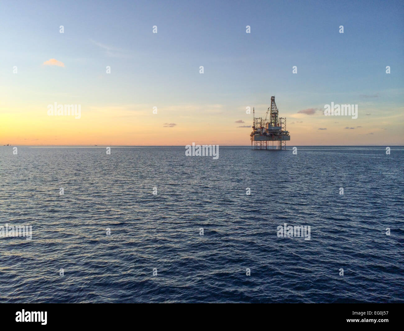 Oil rig at sunset Stock Photo