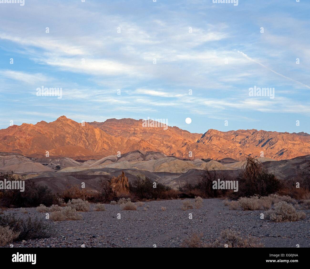 Sun setting on mountains and moon rising, Death Valley, Death Valley ...