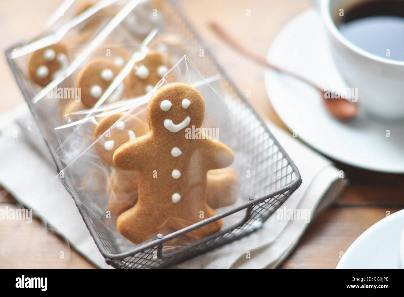 Gingerbread men in a row and coffee on table Stock Photo