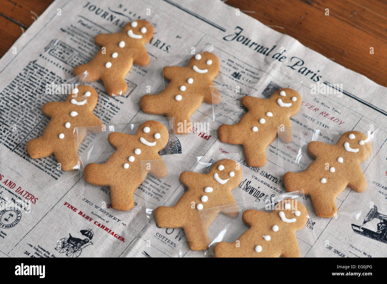 Gingerbread men on newspaper Stock Photo